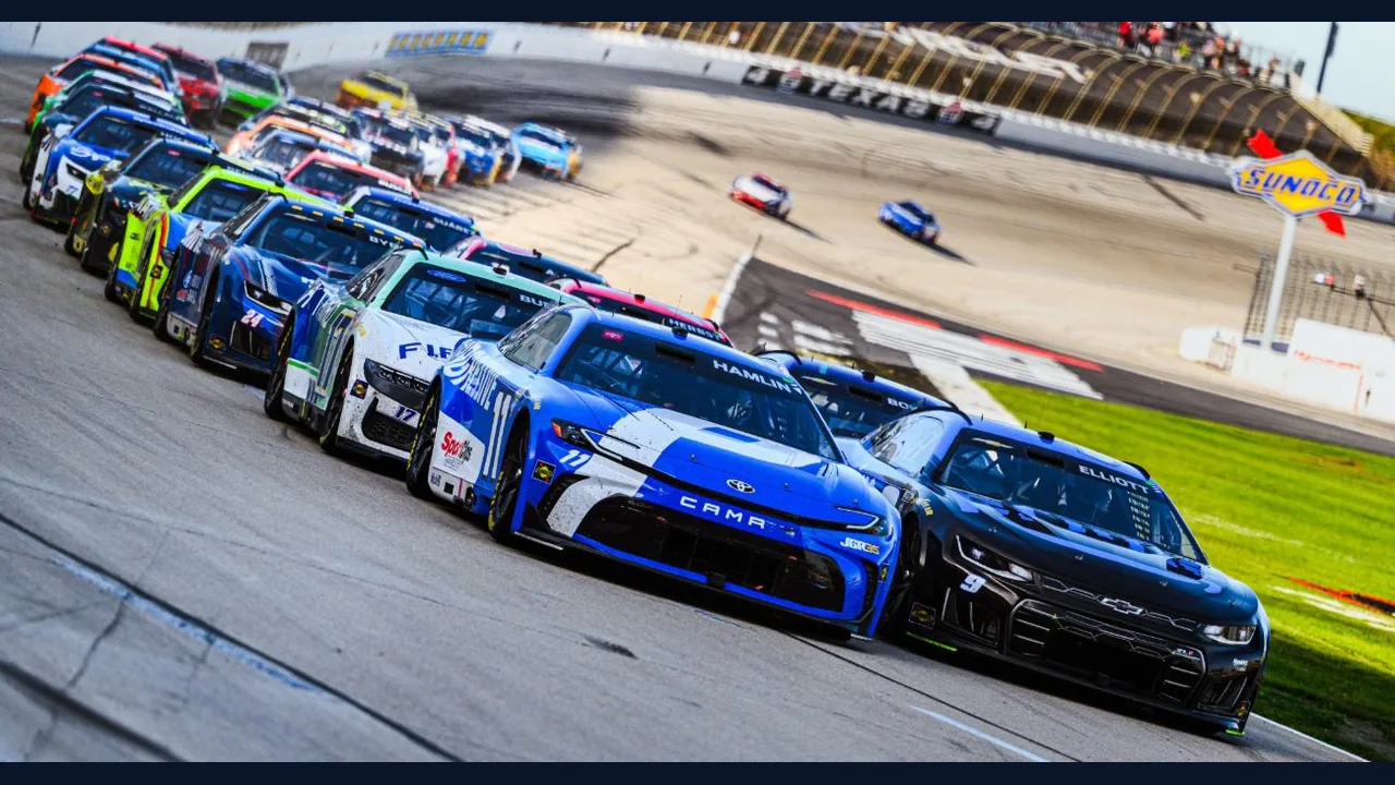 Stock cars racing side by side on a track