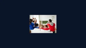 Friends watching a soccer match on TV at home